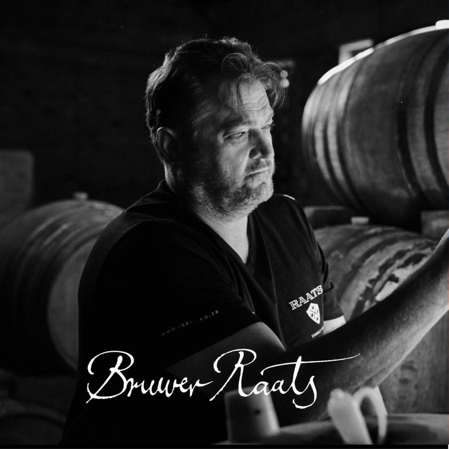 Winemaker inspecting barrels at Bruwer Raats winery in Stellenbosch.