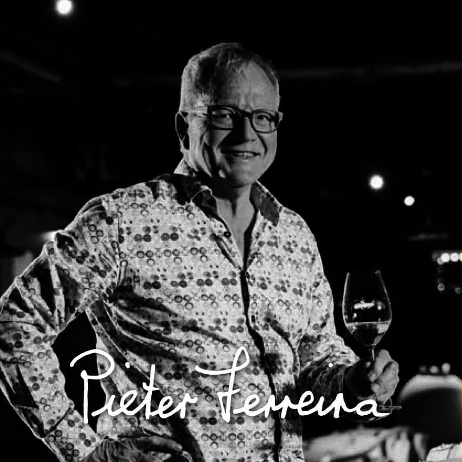 Pieter Ferreira showcasing a glass of Stellenbosch wine.