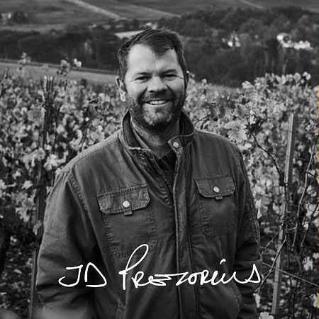 Jd Prezorius Smiling In A Stellenbosch Vineyard, Showcasing South African Wine Heritage.