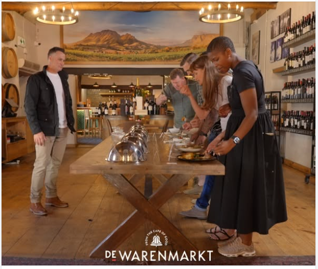 People gathered at a buffet table for Die Wynmeester tonight at De Warenmarkt